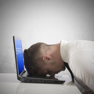 registry cleaners regclean pro overview benefits man with head on open laptop error on display gray background